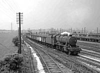 20BKH 48715Stanier 8F with a train of ’empties’ travelling from the Bury direction, passing the Permanent Way Bags yards, Yorkshire bound. B K Hilton.